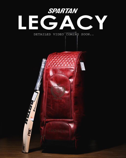 a red leather chair with a bat next to it and the words spartan legacy written