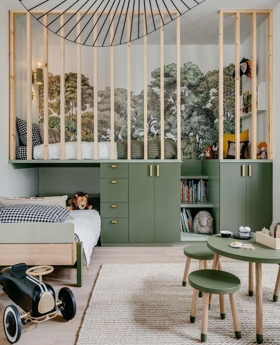 a bedroom with green furniture and an open book shelf above the bed, along with two children's toys