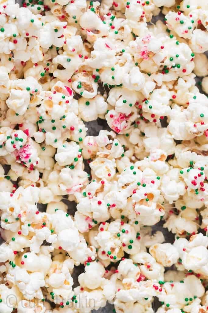 white chocolate popcorn with sprinkles and green and red candies on top