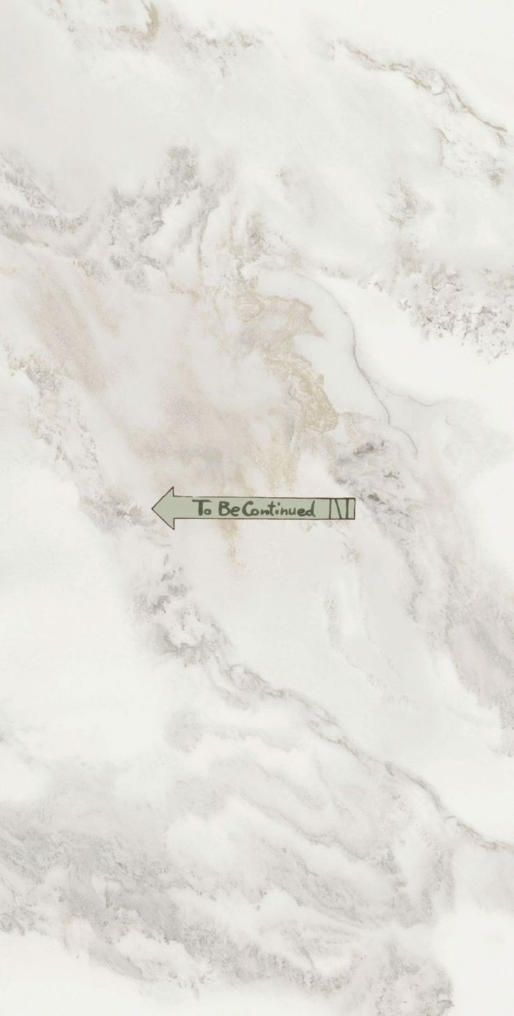 an arrow pointing to the right on a marble surface with white and gray colors,