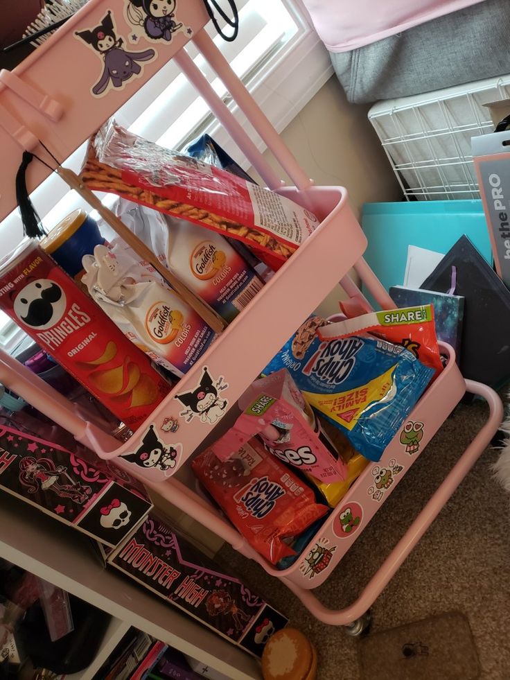 a pink cart filled with candy and snacks