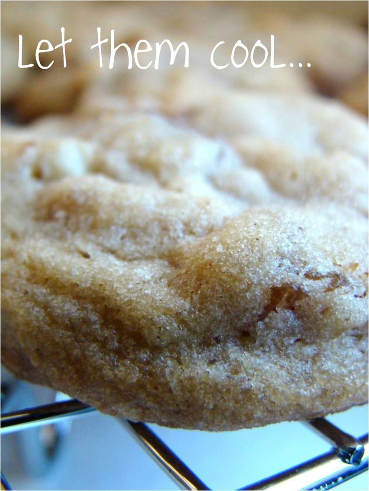 a close up of a doughnut on a rack with the words let them cool