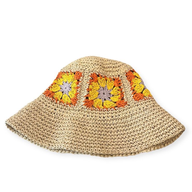 a straw hat with an orange and yellow flower design on the brimmed top