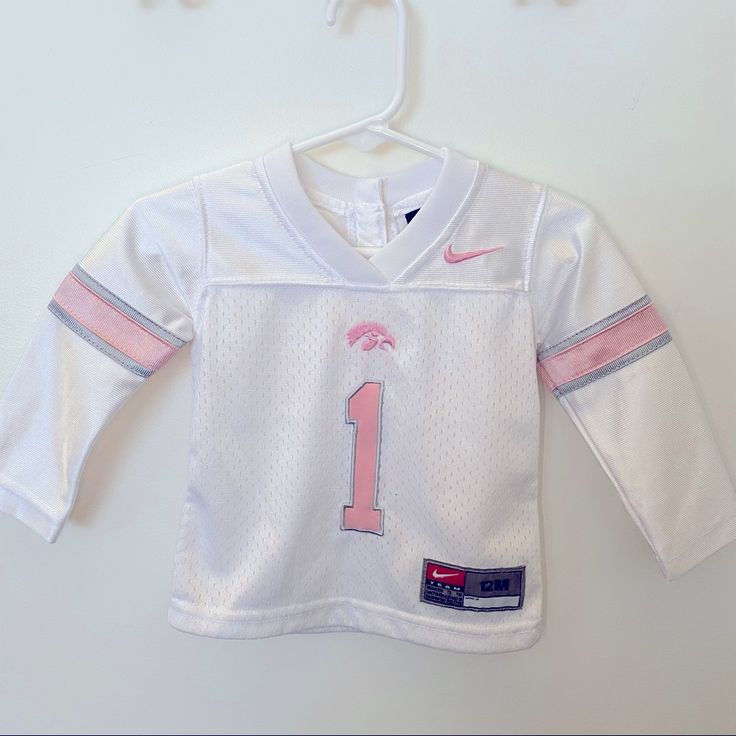 University Of Iowa Baby Girls Jersey Pink & White Sz 12mo. Brand Is Nike And It Was Never Worn So It’s In Like New Condition White Long Sleeve T-shirt For Playtime, Cotton Tops For First Birthday, White Cotton Top For First Birthday, White Fitted Playwear Tops, White Long Sleeve Tops For First Birthday, Fitted White T-shirt For Playtime, White Long Sleeve Playwear For Babies, Cute White Tops For Playwear, Cute White T-shirt For Playwear