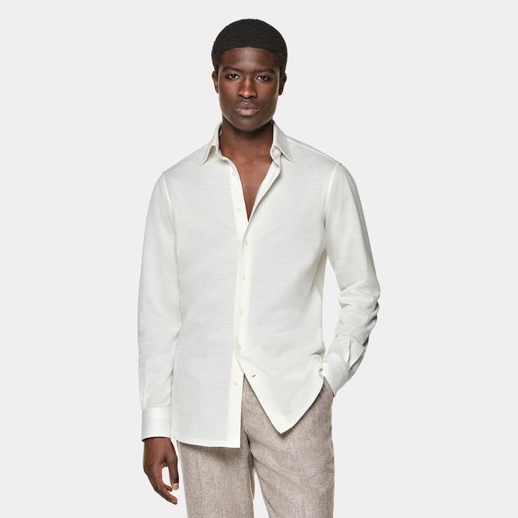 This off-white shirt is tailored to a casual tailored fit and features a classic collar, single cuff, and a French placket. Classic Slim Fit Summer Dress Shirt, Classic Summer Dress Shirt, Slim Fit, White Shirt With Concealed Placket For Summer, Timeless Spring Shirt With Spread Collar, White Casual Dress Shirt With Spread Collar, White Business Tops For Summer, White Shirt With Button Cuffs And Fold-down Collar, Classic Tailored Single Breasted Top, White Shirt With Hidden Button Closure For Spring