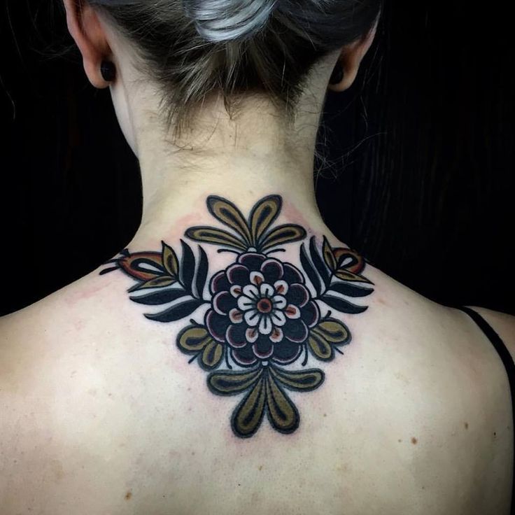 the back of a woman's neck with flowers on it and an image of a flower