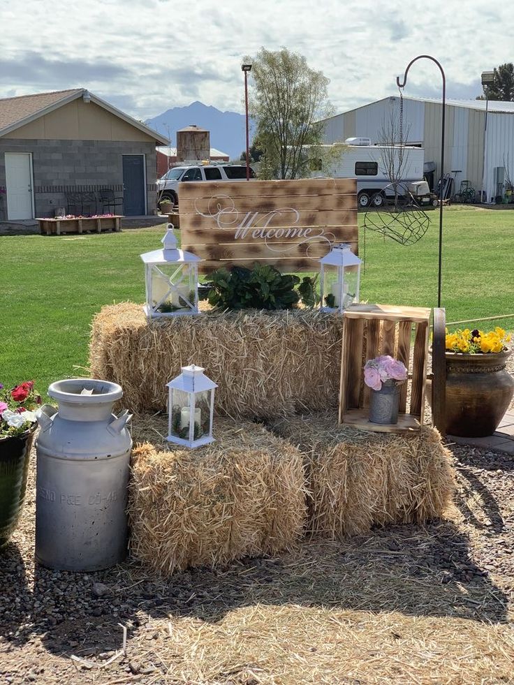 a hay bale with flowers and candles on it