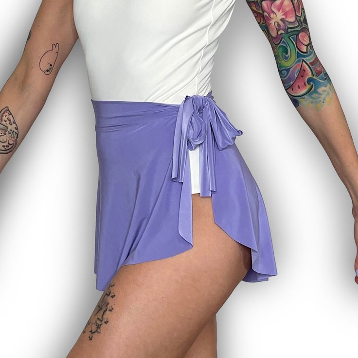 "Demi Wrap Skirts are made with an opaque, lightweight, poly/spandex blend fabric that is lightweight, 4-way stretch, and drapes beautifully on the body. Slightly longer in the back, these fun and versatile ballet mini skirts can be doubled as a swimsuit cover. Wrap style with a 1.75\" fabric waistband that ties on your left and has a sweetheart cut at the right side seam." Fitted Skirt With Built-in Shorts For Summer, Spring Fitted Skirt With Built-in Shorts, Versatile Summer Tennis Skirt With Built-in Shorts, Flowy Skirted Swim Skirt With Built-in Shorts, Swim Skirt With Built-in Shorts And Flowy Fit, Spring Stretch Skirt With Wide Waistband, Chic Fitted Mini Skirt With Tie Waist, Spring Skirt With Wide Waistband And Stretch, Chic Summer Elastane Skort