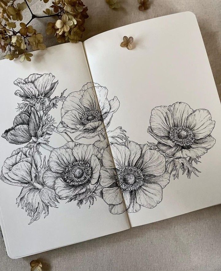 an open notebook with flowers drawn on it