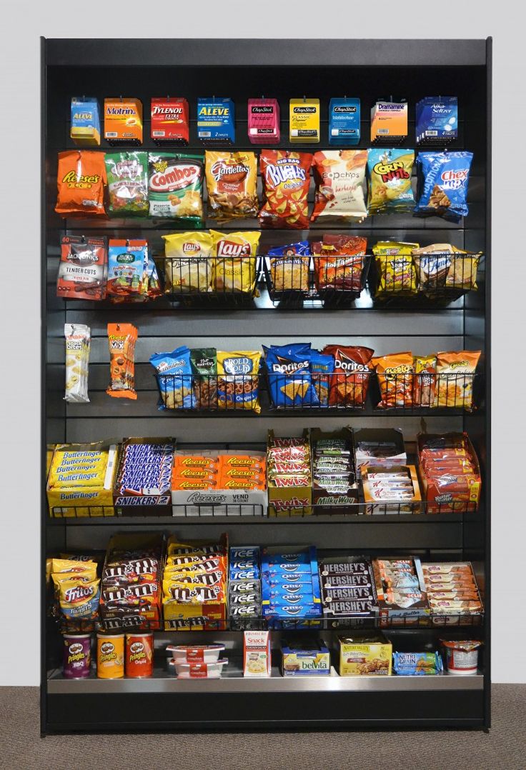 a display case filled with lots of different types of snacks and food items on shelves