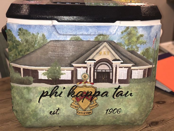 a cooler with a painting of a house on it's front and side panels