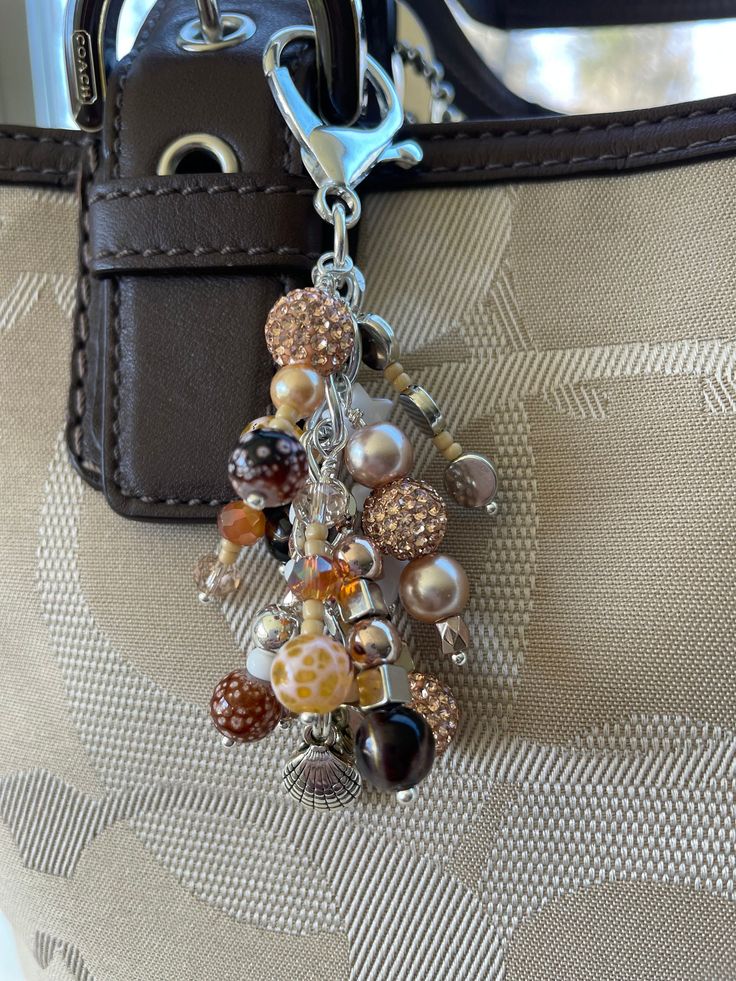 a handbag is adorned with beads and charms