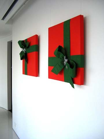 two red and green wrapped gift boxes on the wall