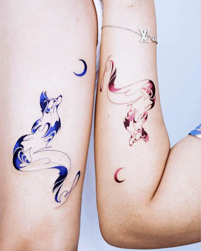 two women with matching tattoos on their legs