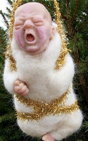 a white and gold christmas ornament hanging from a tree with its mouth open