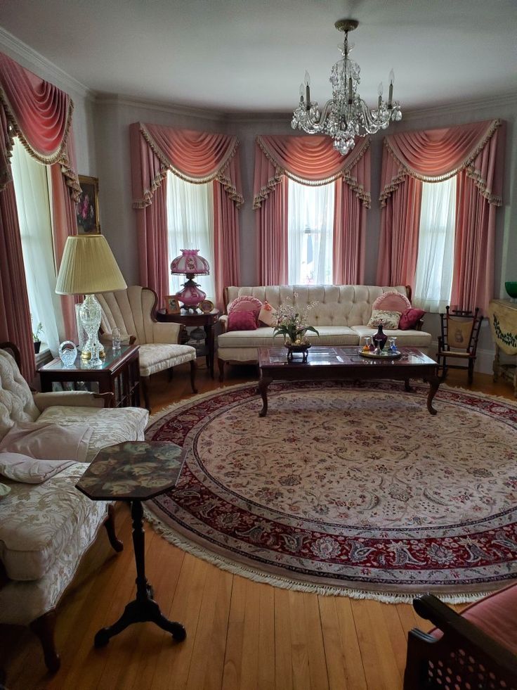 a living room filled with furniture and a chandelier