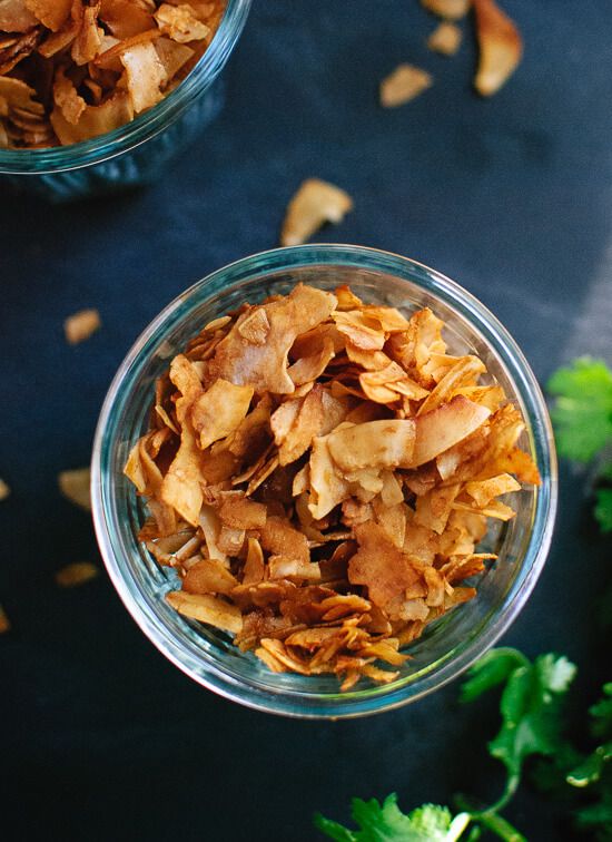 two bowls filled with food sitting on top of a blue tablecloth next to parsley