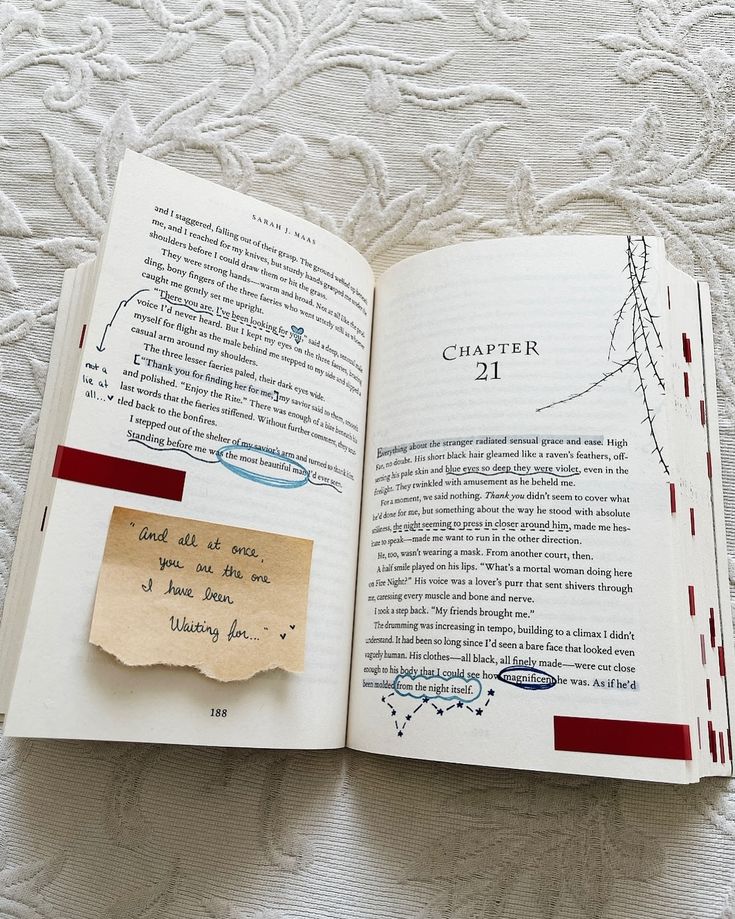 an open book with writing on it and a piece of paper pinned to the page