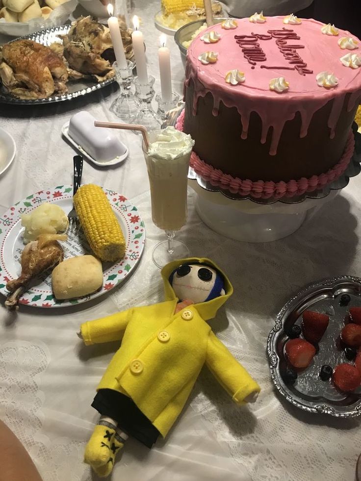 a table topped with cakes and desserts covered in frosting