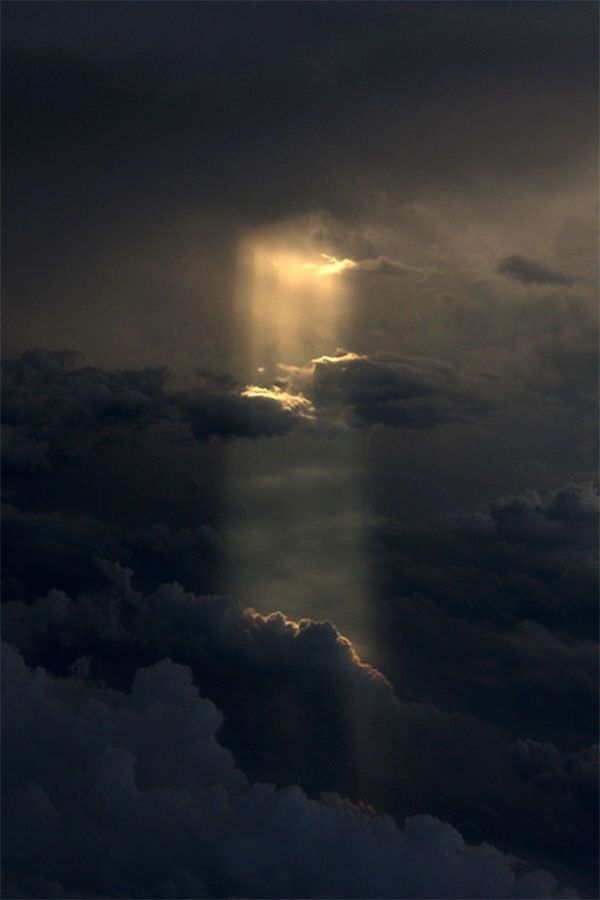 the sun shines through dark clouds in this photo