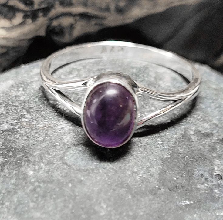 These rings are old store stock- unworn.They are top quality vintage amethyst set in .925 sterling silver. Amethyst is used as a protection stone and is said to lessen stress and negative energy. The stone is about 1/4 of a inch tall or 7 by 5 mm. This retailed at $52. It comes in a tiny ring box. Classic Amethyst Oval Cabochon Ring, Formal Spiritual Amethyst Ring, Silver Amethyst Cabochon Rings, Silver Amethyst Cabochon Ring For Anniversary, Purple Oval Cabochon Hallmarked Ring, Oval Amethyst Healing Ring, Spiritual Oval Purple Amethyst Ring, Oval Amethyst Ring For Healing, Spiritual Amethyst Oval Rings