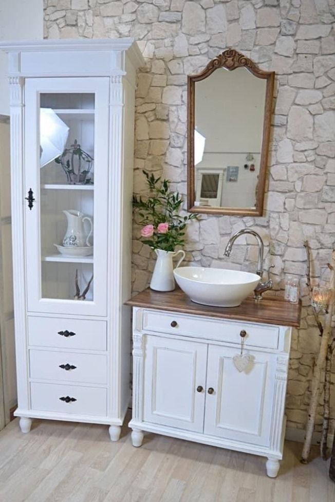 a bathroom with a sink, mirror and cabinet in it's centerpieces