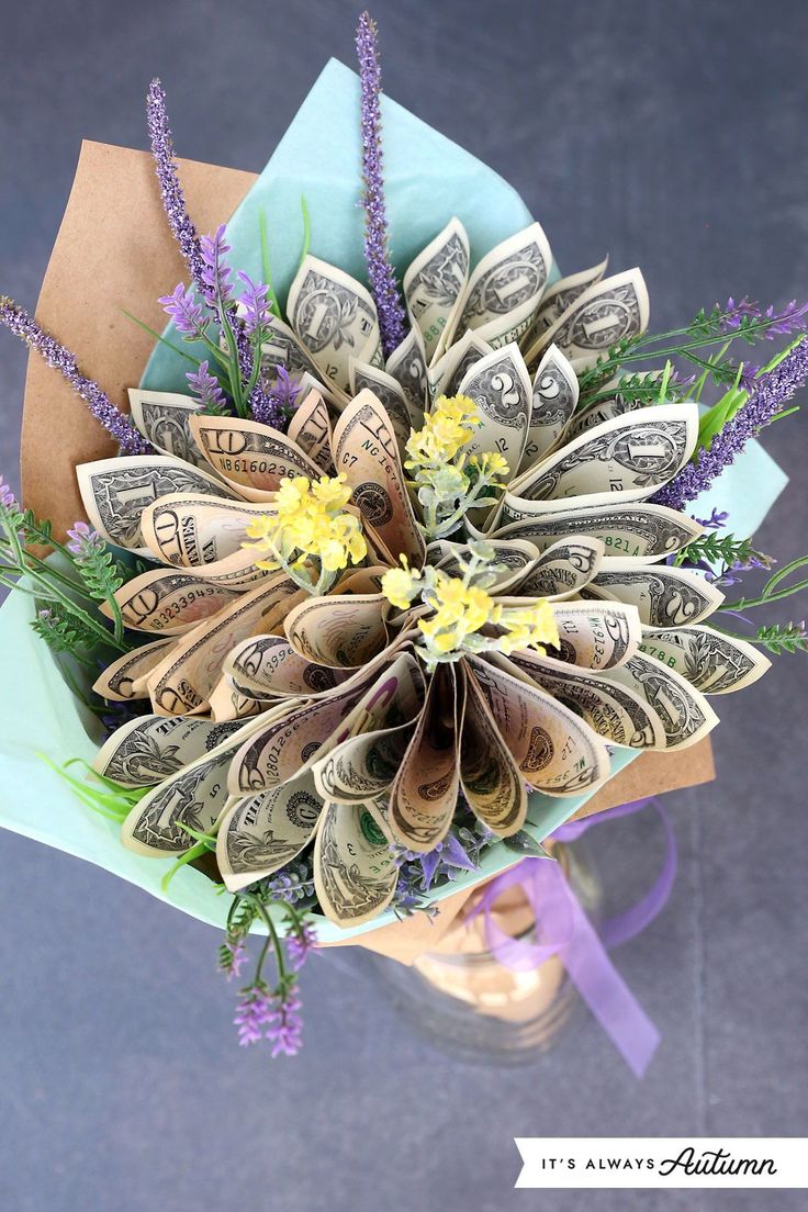 a bouquet made out of dollar bills and flowers