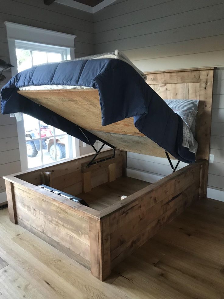 a bed with a wooden frame and mattress on it's side in a room