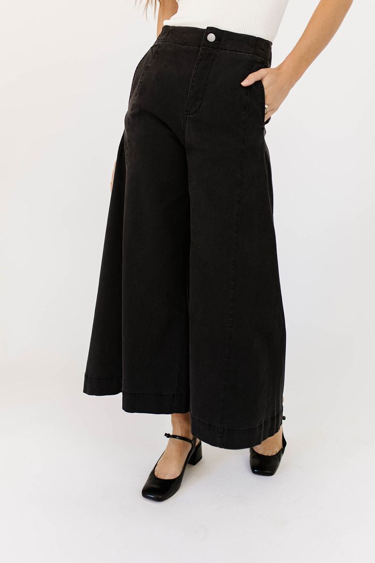 a pair of black wide-leg pants that are sooo good, you’ll never want to take them off. the high-rise + fitted waistline gives it “business casual” charisma, while the flowy loose legs keep things real + relaxed. full of versatility, you can dress them up or down for any occasion. black // wide leg, high waisted, one button zip fly, belt loops, pockets paired with our matilda mesh top + lover denim vest model is 5'8" + wearing a small measurements are approximate + taken while laying flat small : Chic Wide Leg Flare Jeans In Washed Black, Chic Wide Leg Washed Black Flare Jeans, Black Wide Leg Culottes For Spring, Black Wide-leg Culottes For Spring, Washed Black Wide-leg Pants For Fall, Chic High Rise Wide Leg Pants With Pockets, Relaxed Fit Wide Leg Workwear Pants, Chic Wide-leg Fall Culottes, Washed Black Relaxed Fit Work Pants