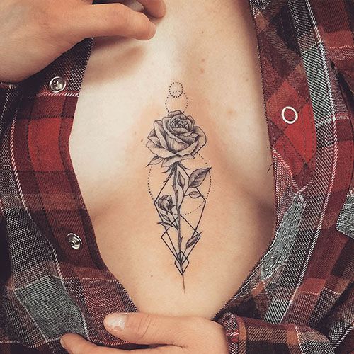 a woman's chest with a rose and diamond tattoo on her left side breast