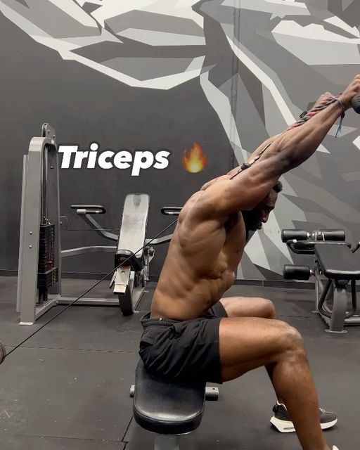 a man doing exercises on a bench in a gym