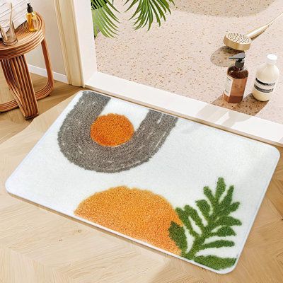 a door mat with an orange and grey design on it