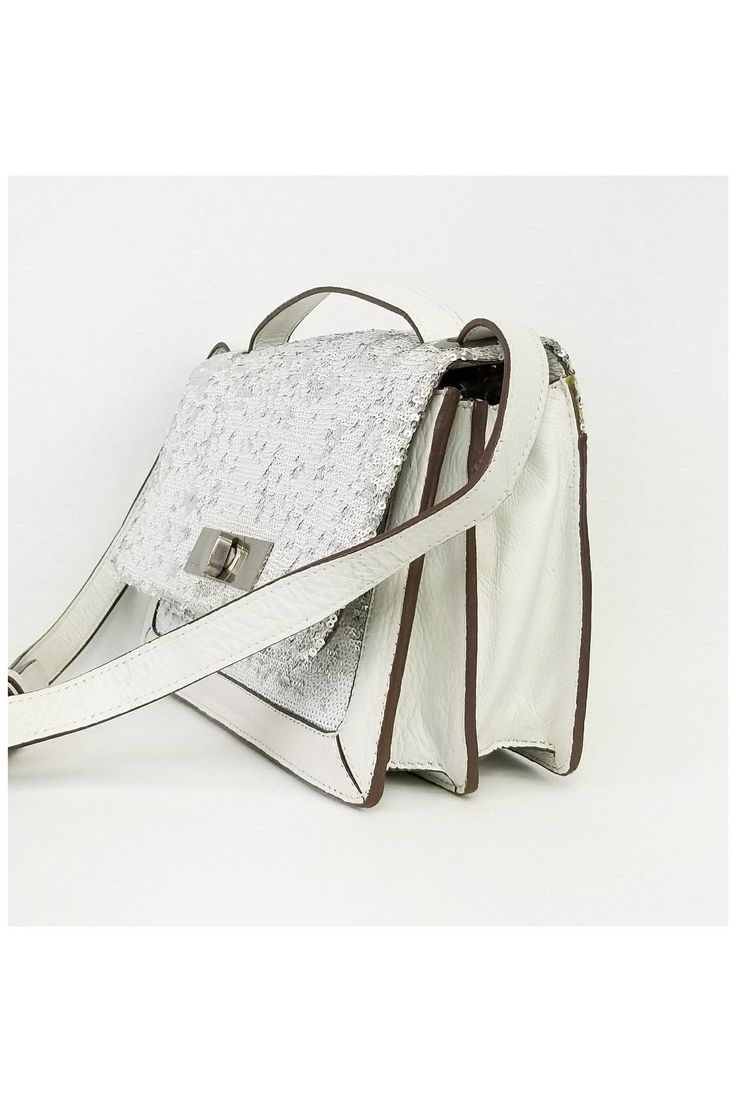 This leather crossbody is designed with white and silver sequins. A great day to night bag, it has multiple interior compartments. Comes with an adjustable crossbody strap for versatility. 70% Leather, 30% acrylic Fold over top closure Turn lock front closure Sequins on front Adjustable shoulder strap 2 interior open pockets 1 interior zip pocket Silver-tone hardware Width 10.75" Height 6.75" Depth 2.5" Strap drop White Party Bag With Silver-tone Hardware, White Crossbody Shoulder Bag With Silver-tone Hardware, White Leather Shoulder Bag With Magnetic Closure, White Flap Bag With Magnetic Closure For Evening, White Leather Flap Bag For Evening, White Crossbody Shoulder Bag With Magnetic Closure, White Crossbody Bag With Silver-tone Hardware, White Crossbody Flap Bag With Detachable Strap, White Leather Party Bags