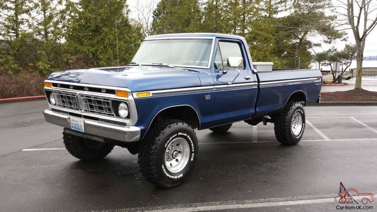 a blue pickup truck parked in a parking lot