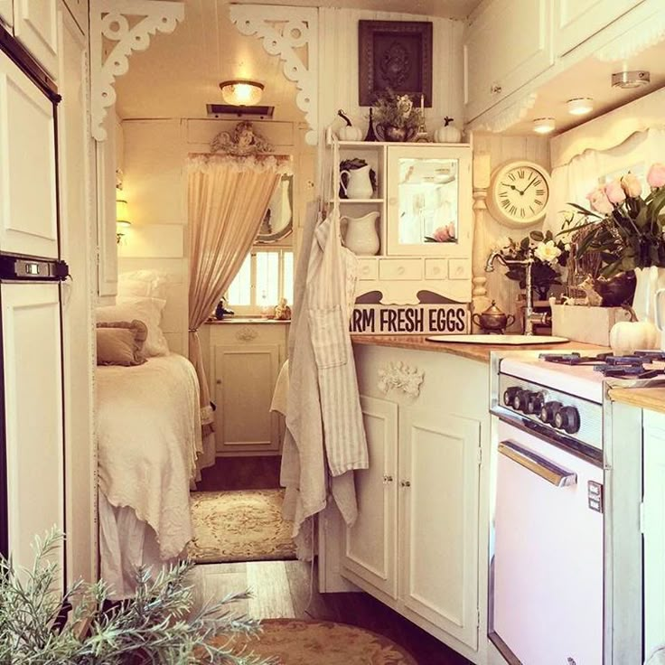 a small kitchen with white cabinets and appliances