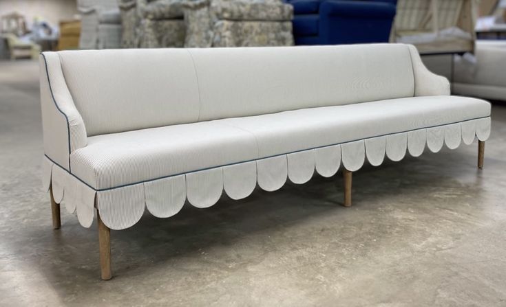 a white couch with scalloped edges in a store