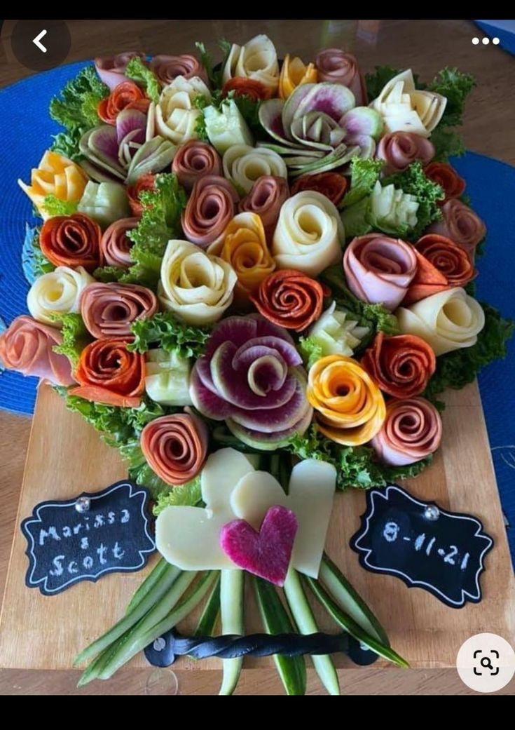 a bouquet of flowers on a table with some chalkboard signs in front of it