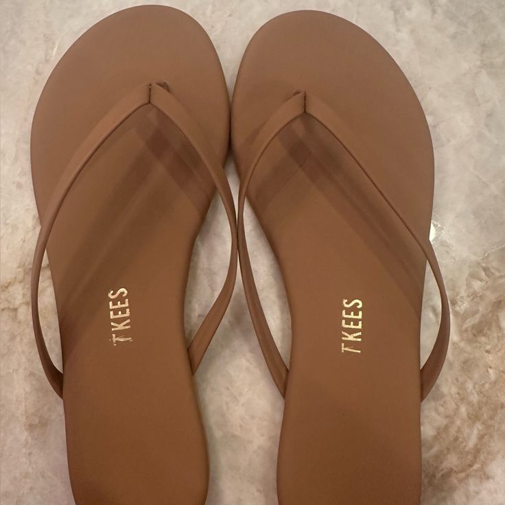 Size 6 (Runs Small) Never Worn (Ordered Wrong Size) Casual Tan Flat Flip Flops, Casual Tan Flip Flops For Spring, Tan Toe Post Sandals For Beach, Tan Flat Sandals For Beach, Casual Tan Flip Flops For The Beach, Tan Flat Flip Flops For Vacation, Tan Open Toe Flip Flops For The Beach, Tan Vacation Flip Flops, Tan Flat Flip Flops For Spring