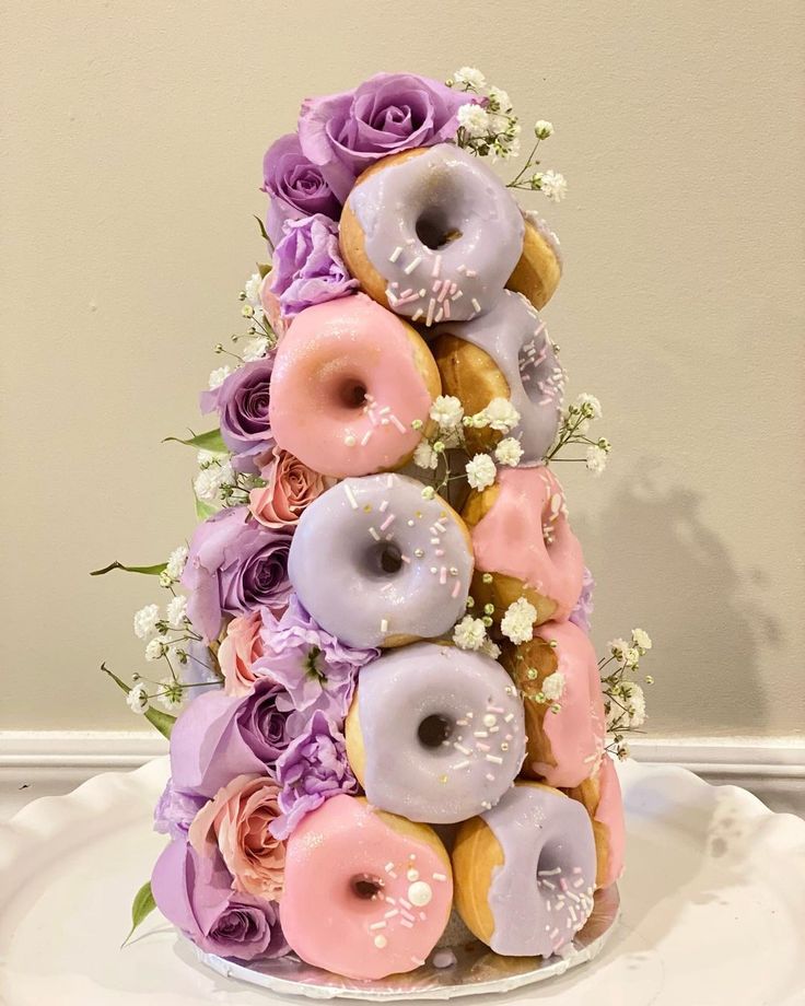 there is a cake made out of doughnuts and flowers