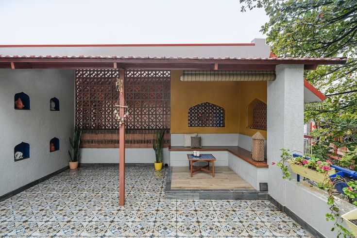 an outdoor living area with tiled floors and walls