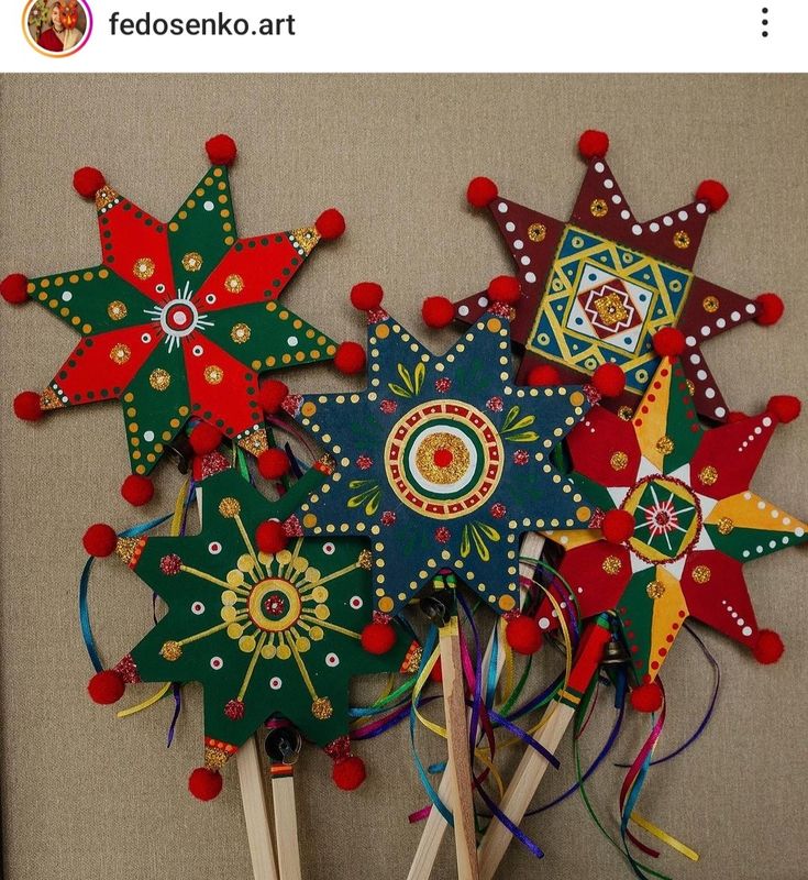 a group of wooden sticks with different colored decorations on top of each other and one has a stick sticking out of it