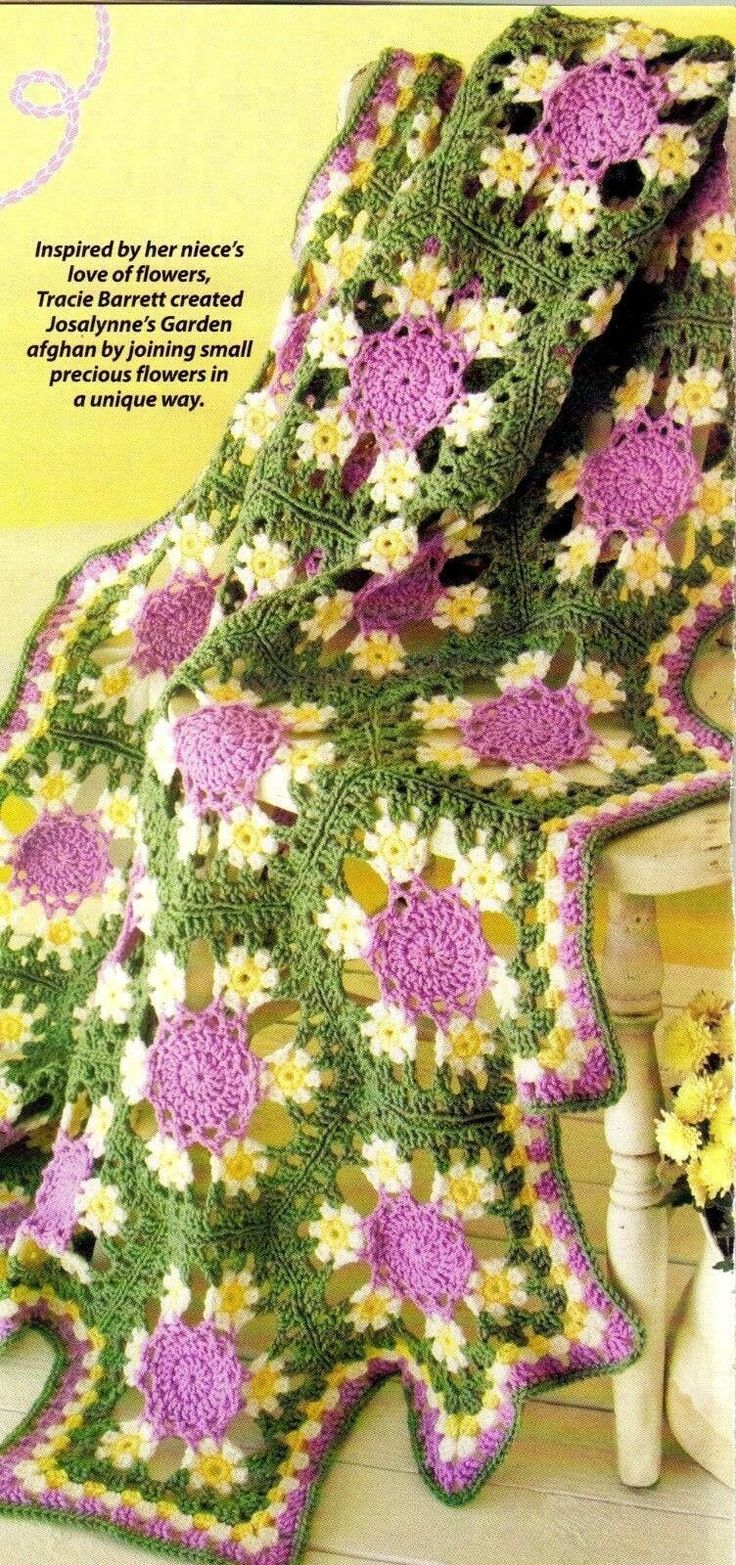 a crocheted blanket with flowers on it