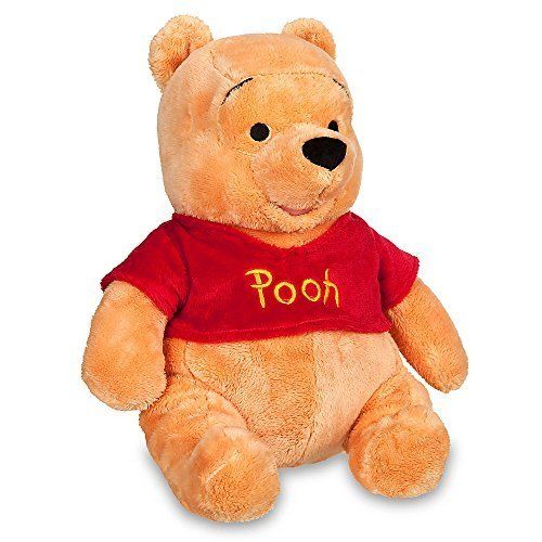 a winnie the pooh stuffed animal with a red shirt on it's chest