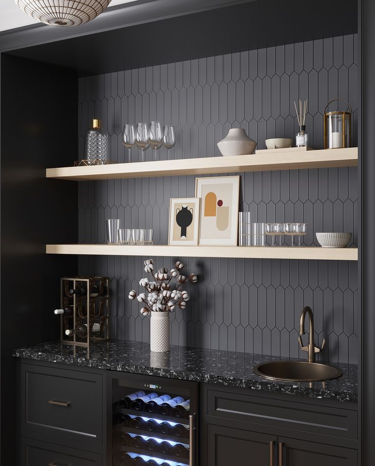 a wine rack with bottles and glasses on top of it in a room that has black walls