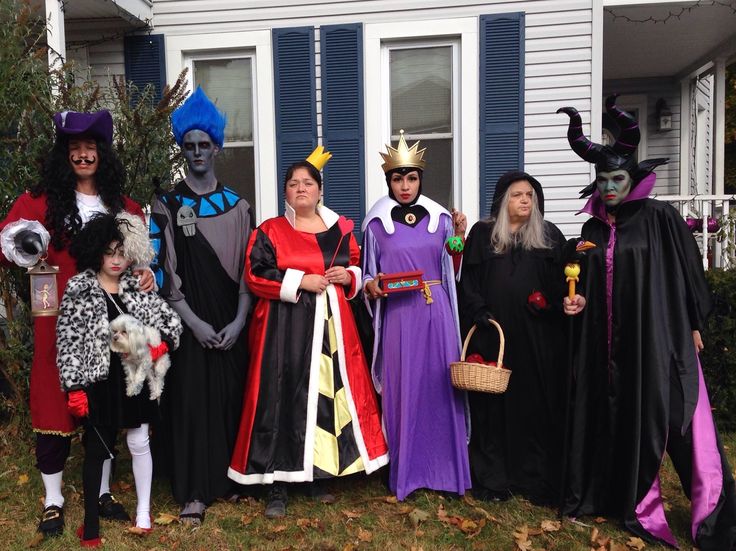 a group of people dressed up in halloween costumes standing next to each other on the lawn