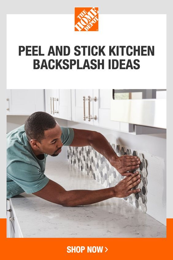 a man is fixing the kitchen backsplash with his hands and looking at it