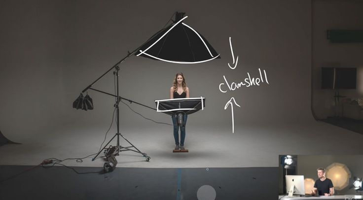 a woman standing in front of a black and white photo with the words chelsea written on it