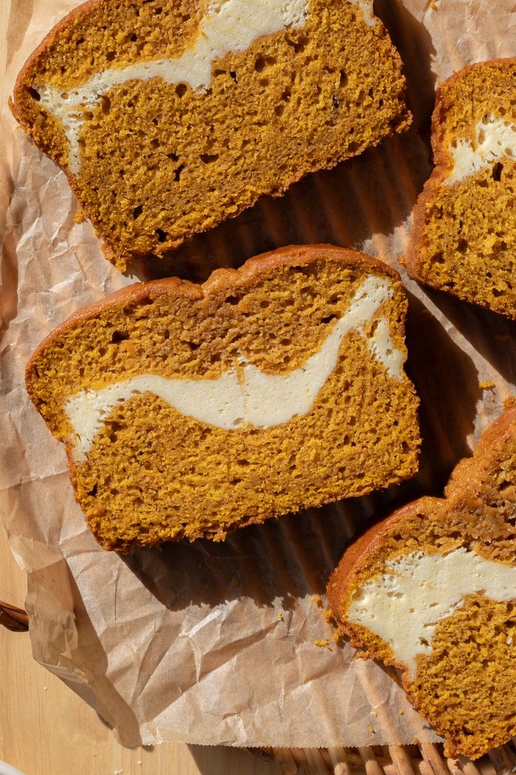 four slices of pumpkin bread with white frosting