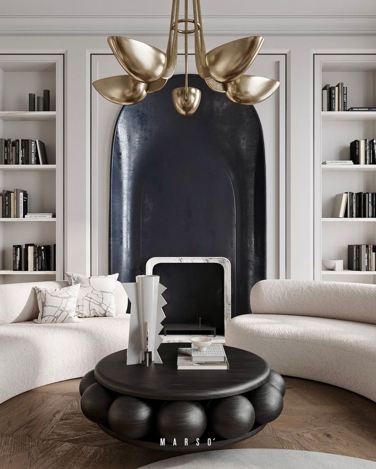 a living room filled with white furniture and lots of books on the shelves above it