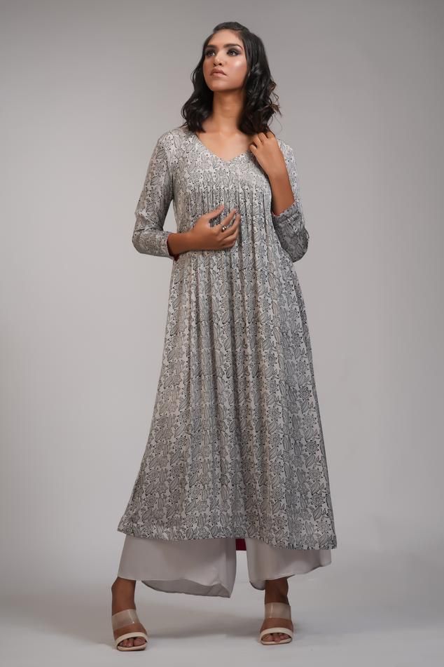 Grey anarkali with floral hand block print and gathered detailing. Paired with palazzo.
Components: 2
Pattern: Hand Block Printed
Type Of Work: Floral
Neckline: V neck
Sleeve Type: Long sleeves
Fabric: Modal Satin
Color: Grey
Other Details: 
Approx weight: 5-7 kgs
Model height: 5ft 9inches, wearing size M
Occasion: Puja - Aza Fashions Traditional Silver Designer Dresses, Designer Anarkali Silver Kurta, Semi-stitched Silver Anarkali Set For Festivals, Silver Anarkali Salwar Kameez For Designer Wear, Silver Anarkali Set For Eid With Traditional Drape, Silver Semi-stitched Anarkali Set For Eid, Bollywood Silver Salwar Kameez For Eid, Silver Bollywood Salwar Kameez For Diwali, Silver Dresses With Resham Embroidery For Diwali